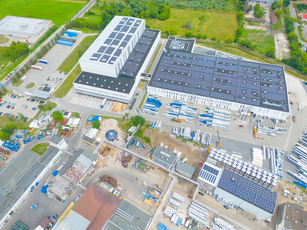 Stock image Industry with low carbon footprint. Industrial warehouses with solar panels on the roof. Technology park and factories from above.