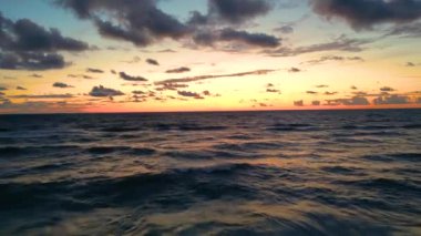 Sea scenery. Drone view. Sunset horizon. Nature beauty. Water landscape. Blue ocean waves relaxing motion on red orange sun light skyline background aerial shot.