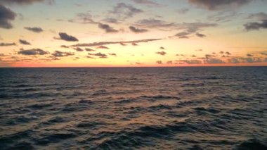 Sea scenery. Drone view. Sunset horizon. Nature beauty. Water landscape. Blue ocean waves relaxing motion on red orange sun light skyline background aerial shot.