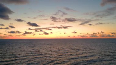 Sea scenery. Drone view. Sunset horizon. Nature beauty. Water landscape. Blue ocean waves relaxing motion on red orange sun light skyline background aerial shot.