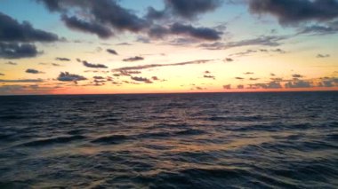 Sea scenery. Drone view. Sunset horizon. Nature beauty. Water landscape. Blue ocean waves relaxing motion on red orange sun light skyline background aerial shot.