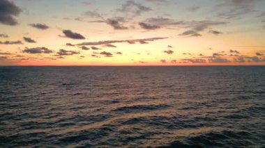 Sea scenery. Drone view. Sunset horizon. Nature beauty. Water landscape. Blue ocean waves relaxing motion on red orange sun light skyline background aerial shot.