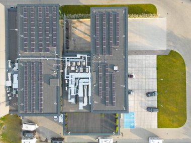 Aerial view of goods warehouse. Logistics center delivery in industrial city zone from above. Aerial view of trucks loading at logistic center