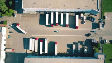 Warehouse storages or industrial factory or logistics center from above. Aerial view of industrial buildings and equipment machines. Aerial view