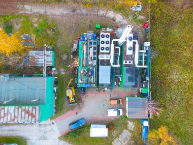 Warehouse storages or industrial factory or logistics center from above. Aerial view of industrial buildings and equipment machines. Aerial view