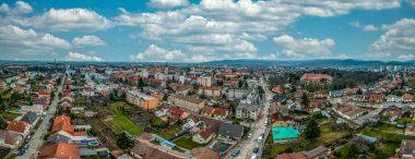 Aerial view of Pezinok (Bazin) medieval castle with restored red roof and medieval wine trading town center with Gothic church and traces of city wall in Slovakia 