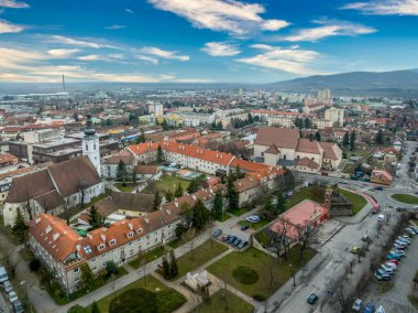 Aerial view of Pezinok (Bazin) medieval castle with restored red roof and medieval wine trading town center with Gothic church and traces of city wall in Slovakia 