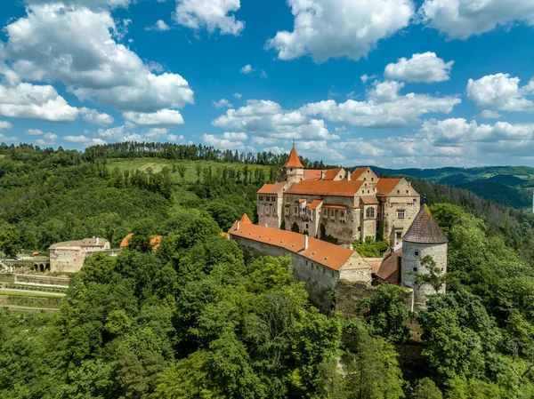 stock image Aerial view of Pernstejn castle with Gothic palace red roof, rectangular and round towers, barbican, forward gun platform in Moravia