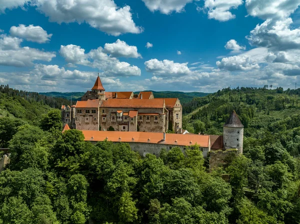 stock image Aerial view of Pernstejn castle with Gothic palace red roof, rectangular and round towers, barbican, forward gun platform in Moravia