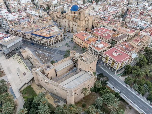 stock image Aerial view of Elche (Elx) historic center, Altamira medieval castle national monument, palm trees dramatic sunset sky