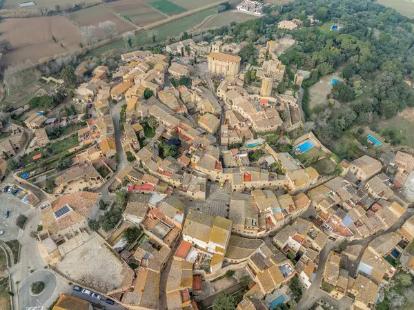 Aerial view of Peratallada, historic artistic small fortified medieval town in Catalonia, Spain near the Costa Brava. Stone buildings rutted stone streets and passageways. Robin hood filming location