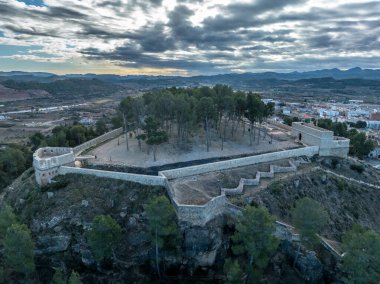 Aerial view of Segorbe castle, restored medieval hilltop stronghold with angled gun platform bastions on each corner, in Castello province Spain clipart