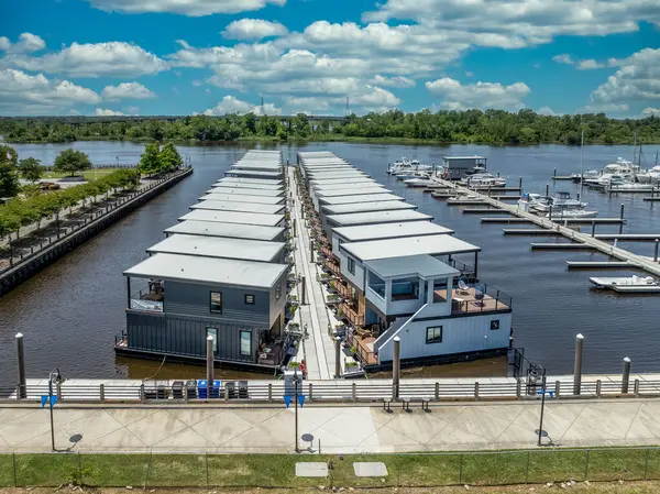 stock image Aerial panorama view of Wilmington North Carolina historic district along the Cape Fear river, with the North Carolina battleship with cloudy sky