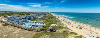 Aerial view of colorful beach front vacation rental properties in the outer banks with beach access, pool, patio, prime American vacation destination clipart