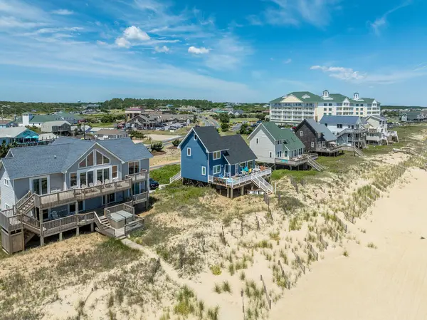 stock image Aerial view of colorful beach front vacation rental properties in the outer banks with beach access, pool, patio, prime American vacation destination