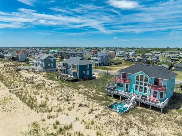 stock image Aerial view of colorful beach front vacation rental properties in the outer banks with beach access, pool, patio, prime American vacation destination