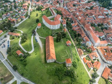 Aerial view of Ptuj castle with red roof gothic renaissance palace building, bastions, towers on a hilltop above the old town, Drava river in Slovenia clipart