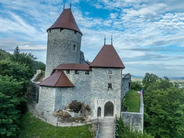 stock image Aerial panoramic view of Zovnek castle, oldest medieval stronghold in Slovenia with partially restored great tower, castle gate, draw bridge