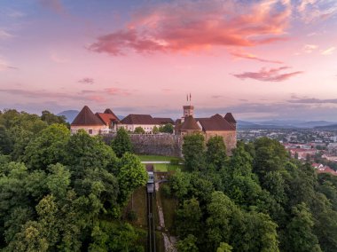 Aerial view of central Ljubljana Slovenia with historic buildings, hilltop castle red roof houses, churches in the Slovenian capital sunset colorful sky clipart