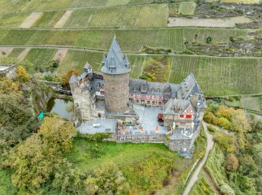 Aerial view of restored Stahleck Castle a 12th-century fortified castle in the Upper Middle Rhine Valley at Bacharach in Germany  with keep (bergfried) housing a youth hostel autumn with vineyard  clipart