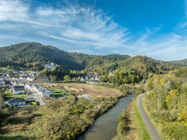 Panoramic view of Altenahr in Germany, with the Ahr river and Burg Kreuzberg, blue cloudy sky clipart