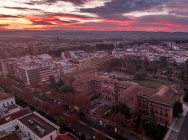 Aerial view of Cordoba University in Spain with dramatic colorful sunrise sky clipart