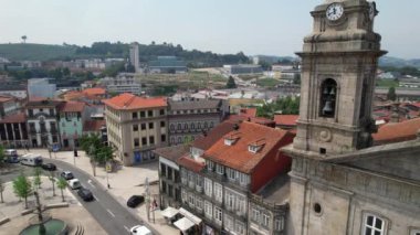 Drone flying over San Peter Church and Toural Square - main square in downtown of ancient city Guimaraes, North of Portugal 