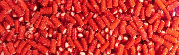 Red gummy candies in a shop window. Sweet Food texture