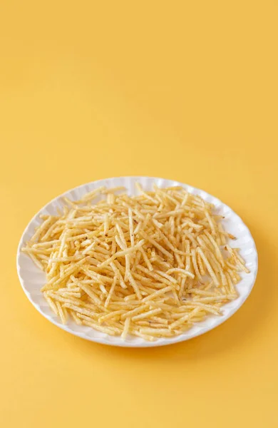 Batata palha - potato straw on yellow paper background with copy space