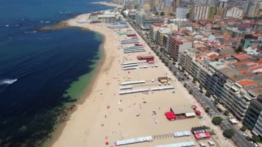 Aerial drone view of the beach in the City of Povoa de Varzim on a bright sunny summer day, Porto region, Portugal. 