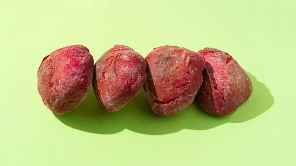 stock image Red purple Beetroot buns on green background. Healthy bread concept