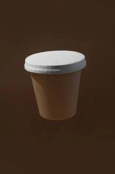 Recyclable paper cup levitation made from biodegradable brown paper with paper white cover on a brown background