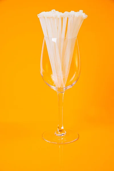 stock image nylon cable ties in glass in jar in bucket on orange background front top view isolated