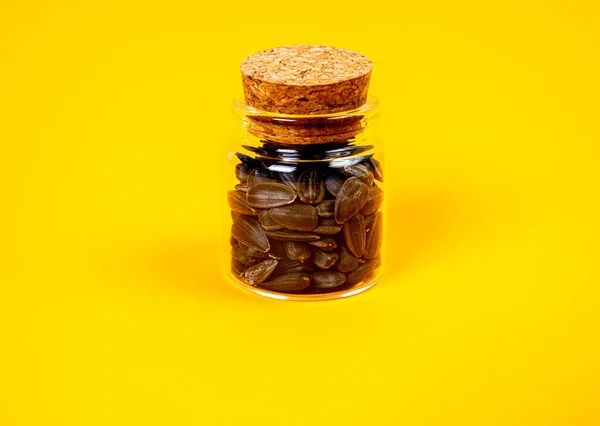 stock image white sunflower seeds in glass jar. in bucket sunflower seeds on black background. concept white sunflower seeds