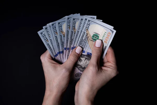 stock image two hands with dollars. Closeup female hand giving money for something with isolated on black background,count, paying, shopping with dollar, corruption, counting dollar banknotes on black background