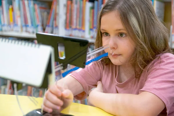 stock image Little girl during a Convergence insufficiency treatment. Vision therapy concept.