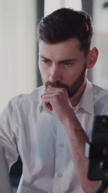 Video klipte beyaz gömlekli iki menone ve dizüstü bilgisayarlarda sakallı çalışmalar, günümüzde dijital çağda üretkenlik ve modern iletişim araçları gösteriliyor.