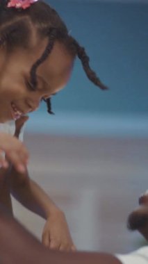 Dokunaklı bir video kumsalda neşeli aile anları gösteriyor. Bir çift gülümsüyor ve bir kadın küçük bir kızı kucaklıyor. Sevgisini gösteriyor.