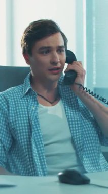 Genç bir adam, modern ve çağdaş ofis ortamındaki görevlerine ve görevlerine yoğun bir şekilde odaklanır.