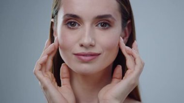 Kesinlikle kusursuz bir cilde ve kendine güvenen büyüleyici bir ifadeye sahip büyüleyici derecede güzel bir kadın.