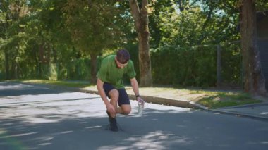 Genç bir adam güneşli bir günde doğanın güzelliğinin tadını çıkararak rahatça dışarı çıkar.