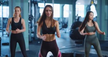 Antrenmandaki kızlar. Beyaz tenli çekici, sportif, çok ırklı kadınlar spor salonunda antrenman yaparken pilates egzersizleri yapıyor. Takım çalışması konsepti.