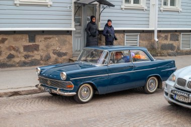 Opel 'in geçmişteki arabası caddede ilerliyor. Geleneksel eski araba gezisi şehrin sokaklarında yapılıyor. Oulu, Finlandiya - 1 Mayıs 2025