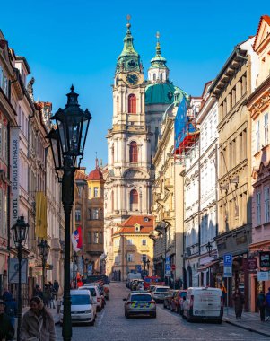 Prag 'ın Küçük Kasabası' ndaki St. Nicholas Kilisesi 'ne giden tarihi sokak manzarası. Prag, Çek Cumhuriyeti - 18 Şubat 2025.