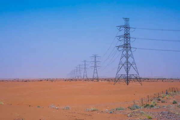 Endless electric line and towers in desert