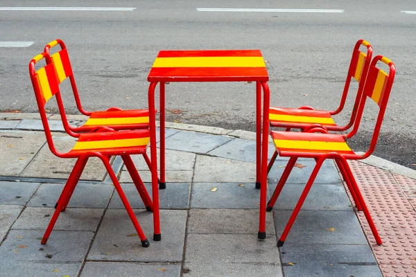 Terrace chairs and table decorated with the flag of Spain. Spain decorated for the World Cup in Quatar. Spain with its Spanish soccer team.