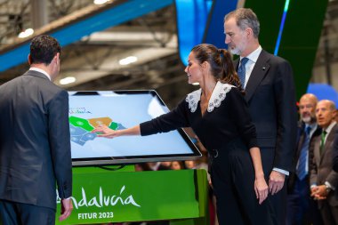Madrid, Spain- January 18, 2023: The King and Queen of Spain and the president of the Andalusian Autonomous Community at FITUR. King Felipe VI and Queen Leticia inaugurate the FITUR fair in Madrid.