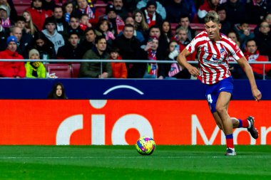 Madrid, Spain- January 21, 2023: Soccer match between Atletico de Madrid and Real Valladolid at Civitas Metropolitano. Marcos Llorente fights for the ball with an opponent.