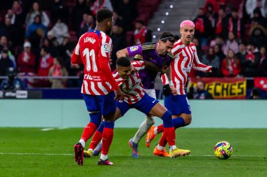 Madrid, Spain- January 21, 2023: Soccer match between Atletico de Madrid and Real Valladolid at Civitas Metropolitano. Antoine Griezman fights for the ball.