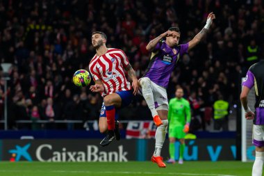 Madrid, Spain- January 21, 2023: Soccer match between Atletico de Madrid and Real Valladolid at Civitas Metropolitano. Mario Hermoso fights for the ball with an opponent
